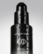 Black skincare bottle with 'Mirror Skin' and 'SKINAD+' branding on a gray background